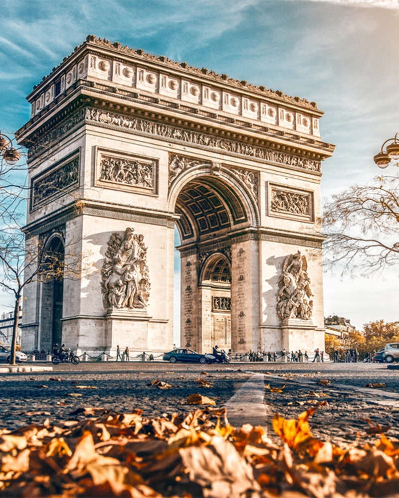 Arc de Triomphe located in Paris, in autumn scenery.